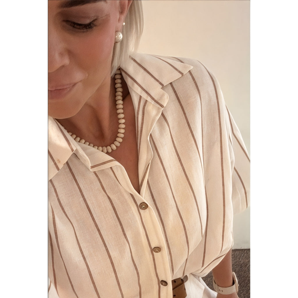 Each One Darcy necklace with fossilised coral beads and magnetic clasp, worn with a striped linen shirt.