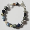 Each One Margot Bracelet with agate, sodalite, obsidian, quartz, lepidolite, sandstone, hawk's eye, jasper, and pearl beads. Toggle clasp.