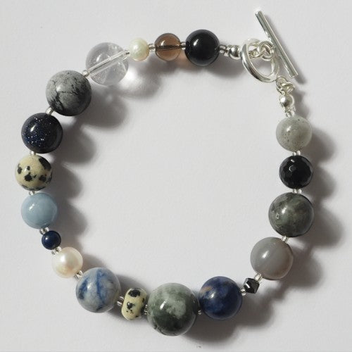 Each One Margot Bracelet with agate, sodalite, obsidian, quartz, lepidolite, sandstone, hawk's eye, jasper, and pearl beads. Toggle clasp.